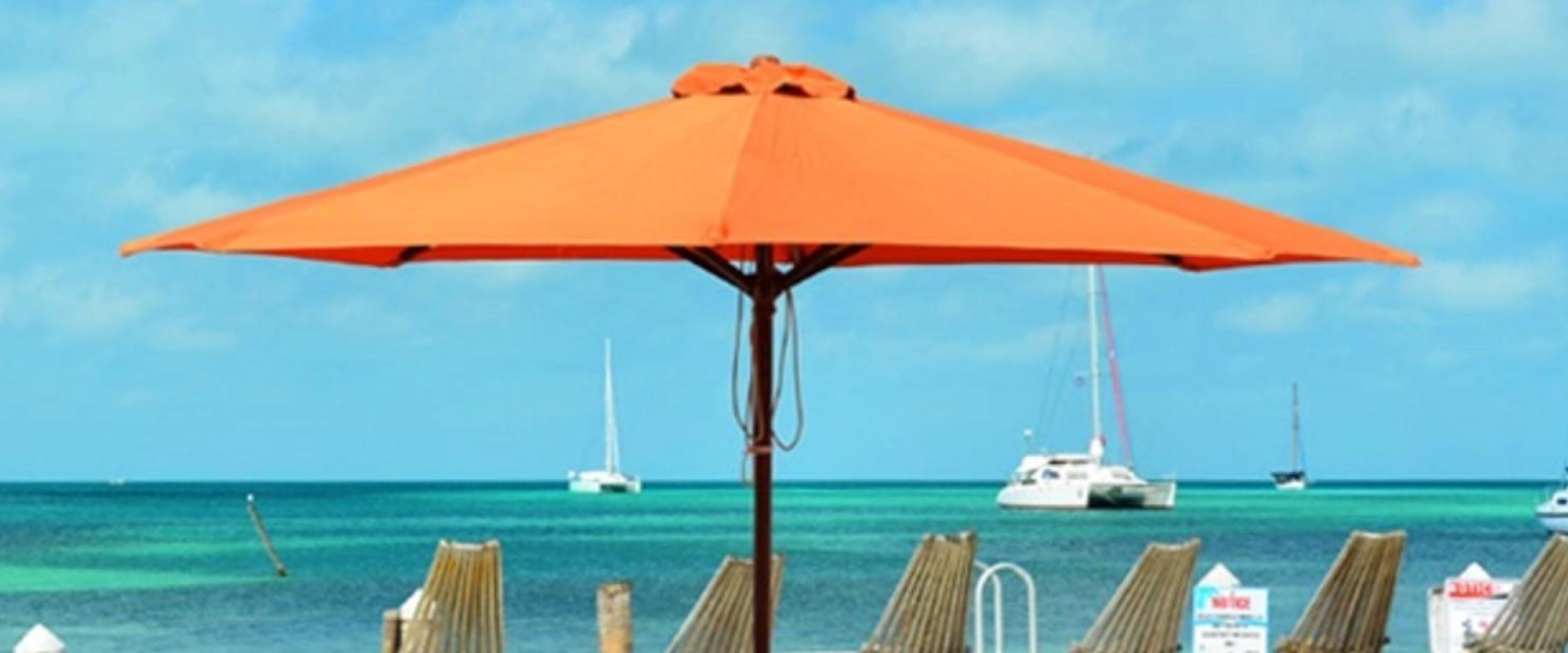 A beach with chairs and an umbrella