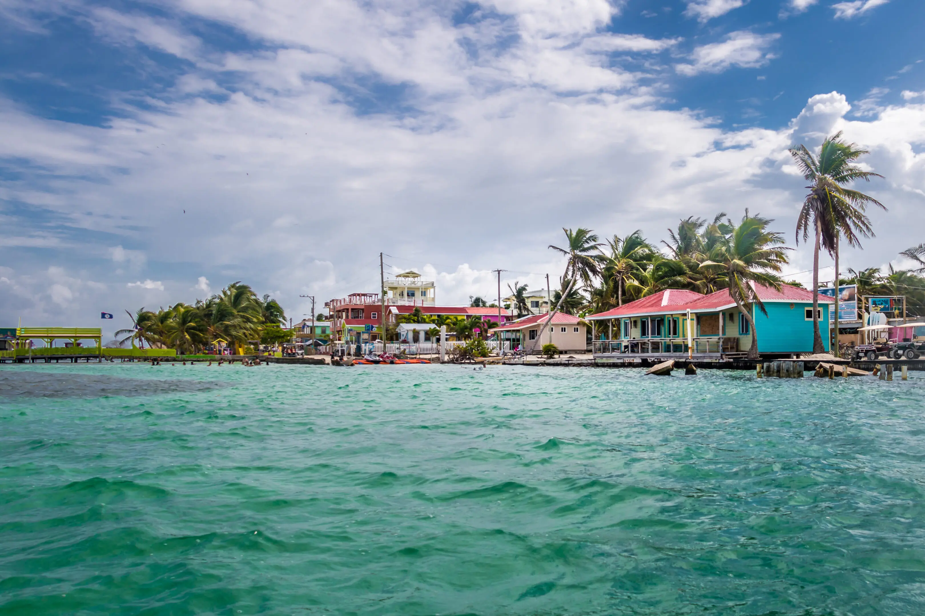 A view of houses on the water from a boat.