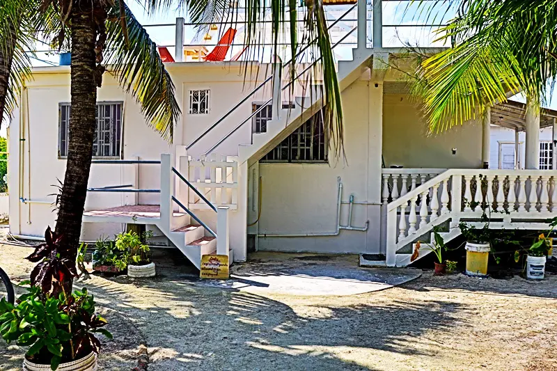 A white building with stairs leading to the top.