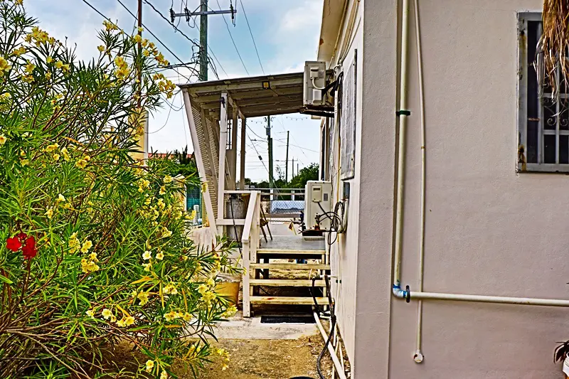 A house with stairs leading to the front of it.