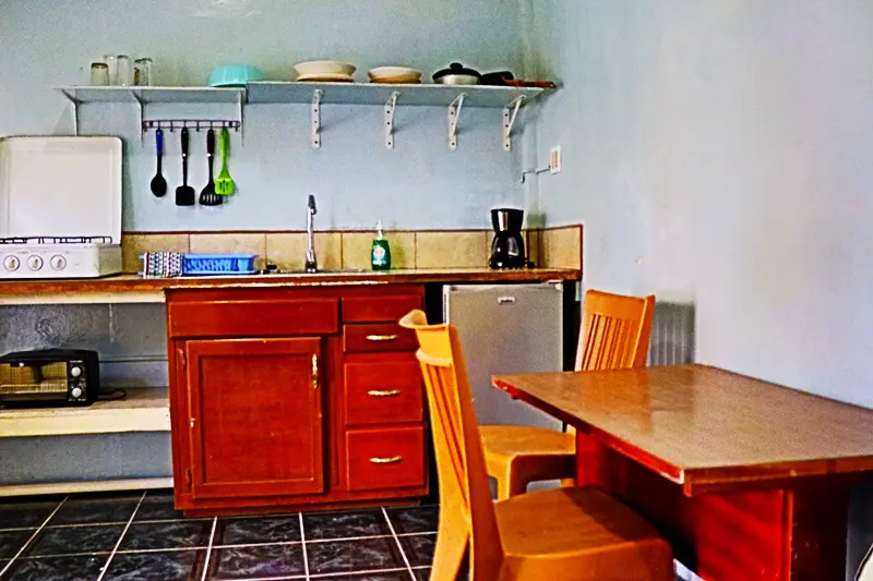 A kitchen with a table and chairs in it