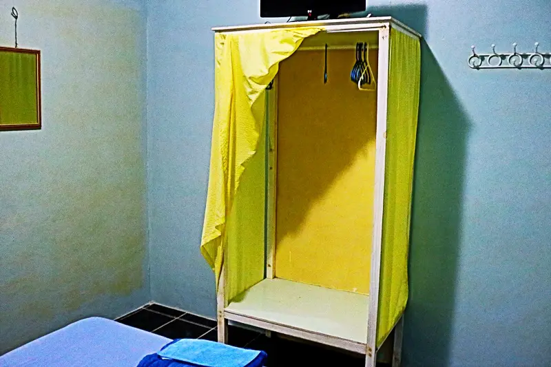 A yellow tent in the corner of a room.