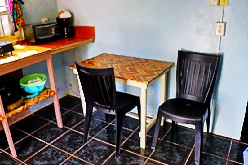 A table and two chairs in a room.