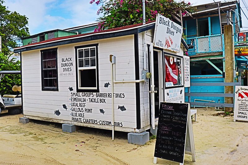 A small white building with black lettering on the side.