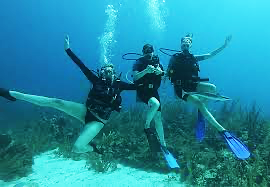 Three people are scuba diving in the ocean.