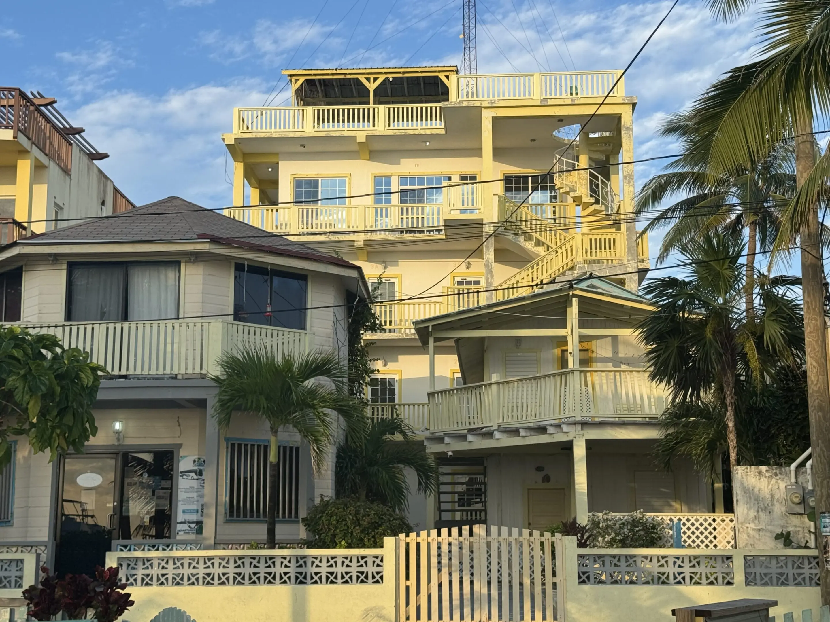 A large yellow building with stairs going up the side.