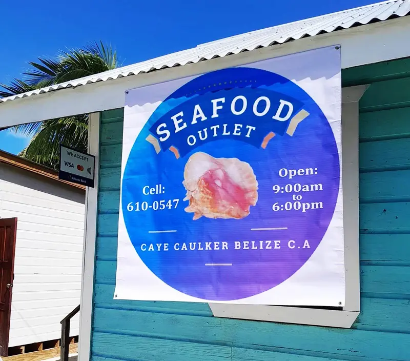 A sign for the seafood outlet on the side of a building.