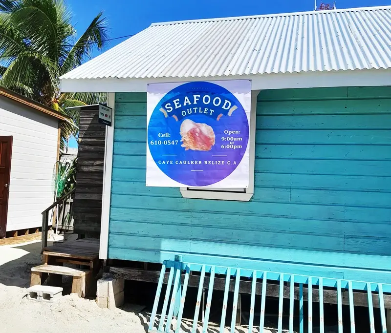 A blue building with a sign on the side of it.