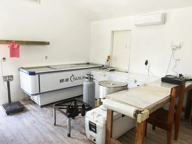 A kitchen with an air conditioner and sink