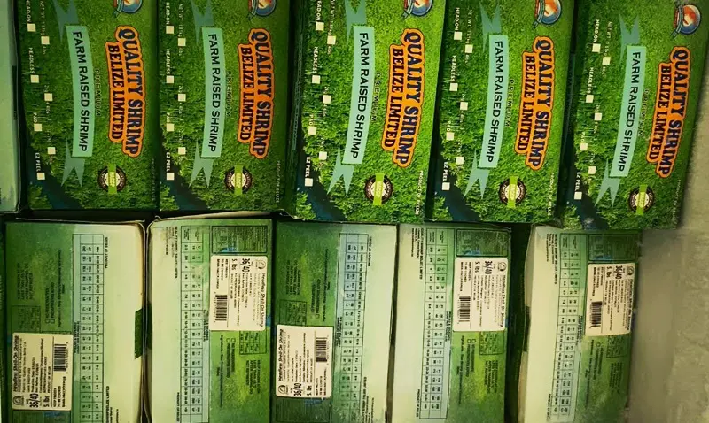 A pile of green grass next to other packages.