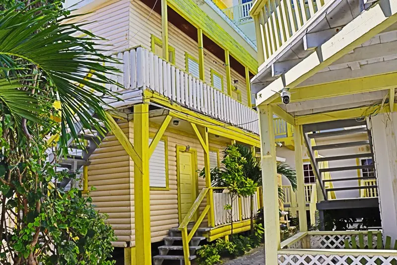 A yellow building with stairs going up the side.