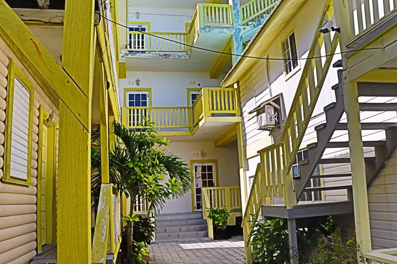 A yellow building with stairs going up to the top.