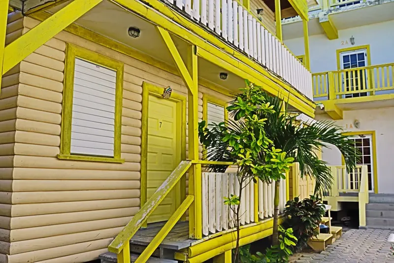 A yellow building with stairs going up the side.