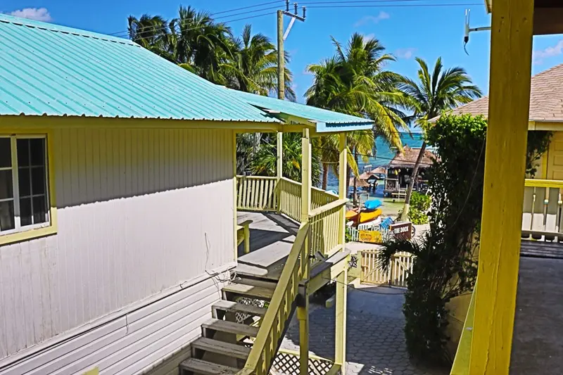 A porch with steps leading to the beach.