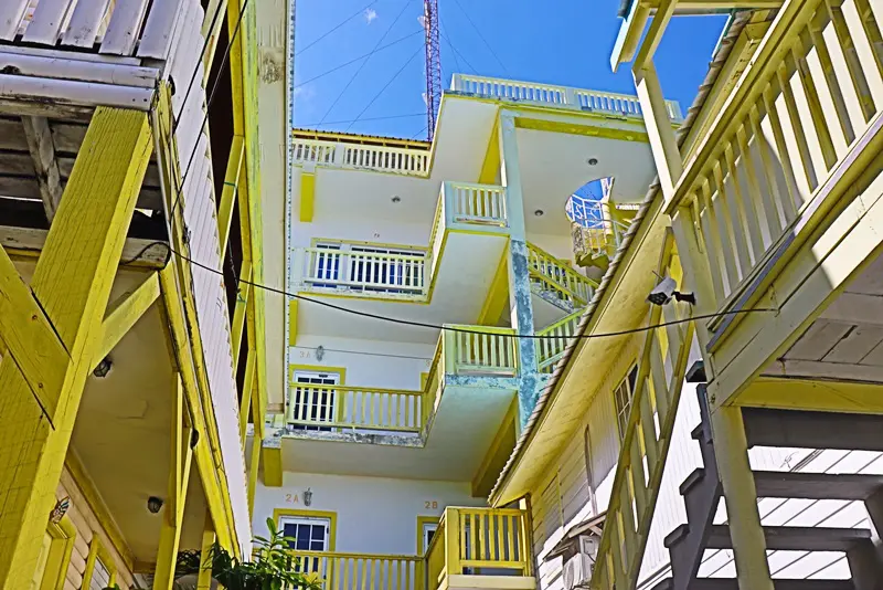 A view of some stairs and balconies in an alley.