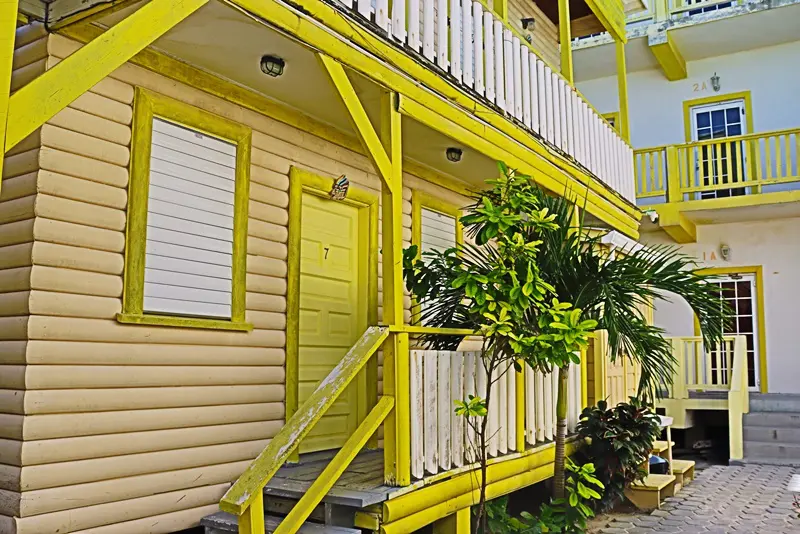 A yellow building with stairs going up the side.