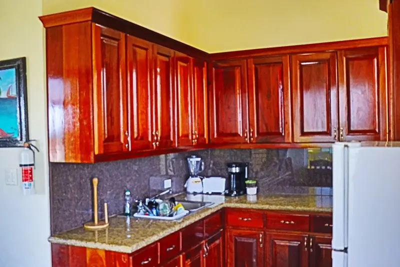 A kitchen with wooden cabinets and granite counter tops.