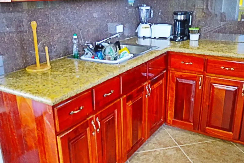 A kitchen with wooden cabinets and granite counter tops.