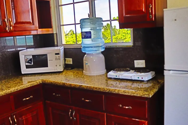 A kitchen with granite counter tops and a microwave.