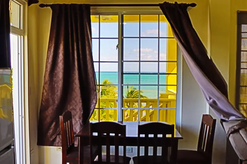 A dining room table with chairs and a window.