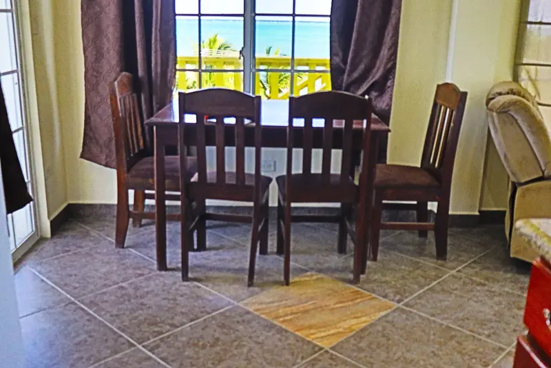 A table and chairs in front of a window.