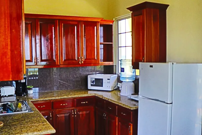 A kitchen with wooden cabinets and white appliances.