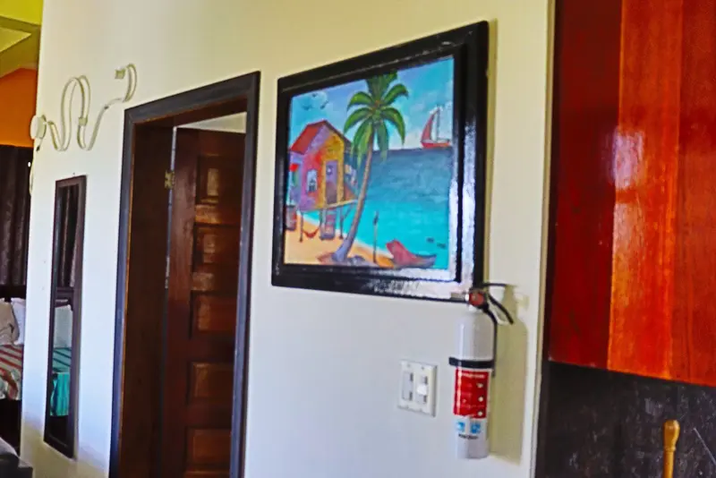 A painting of a beach scene hanging on the wall.