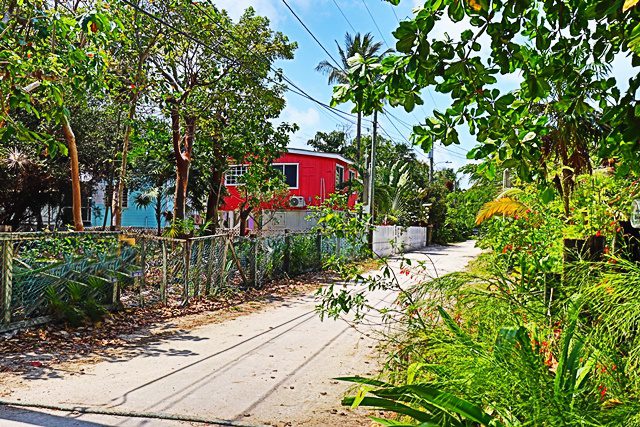 A red house on the side of a road.