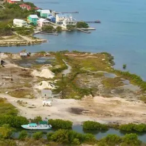 A boat is parked on the shore of an island.