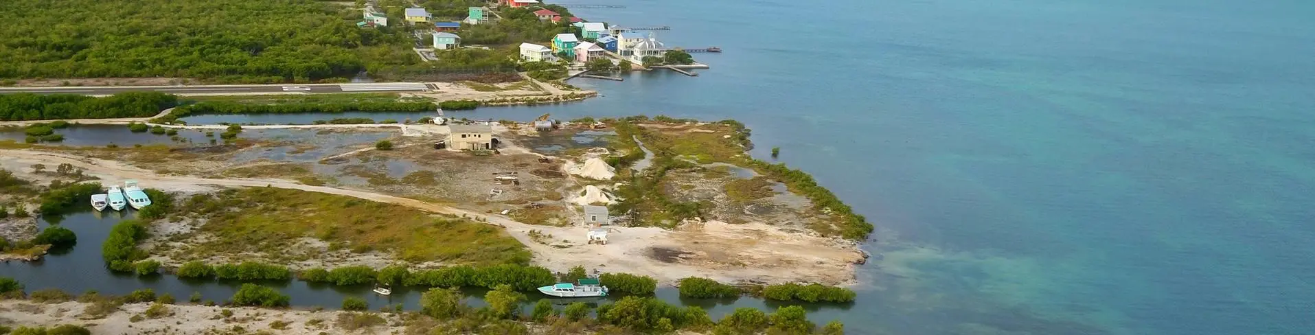 A boat is parked on the shore of an island.