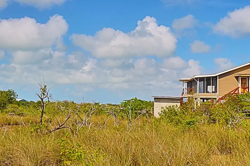 A house sitting in the middle of a field.