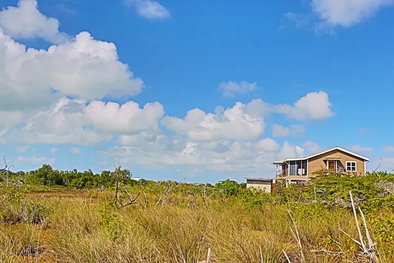 A house sitting on top of a grass covered field.