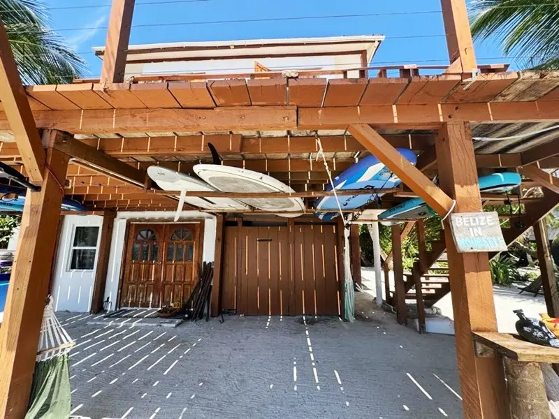 A wooden structure with two surfboards hanging from it.