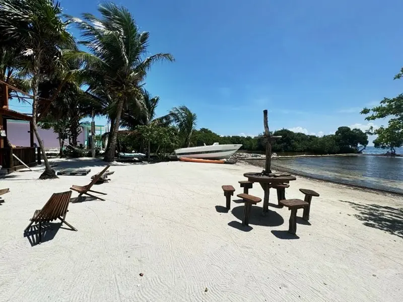 A beach with benches and tables on it