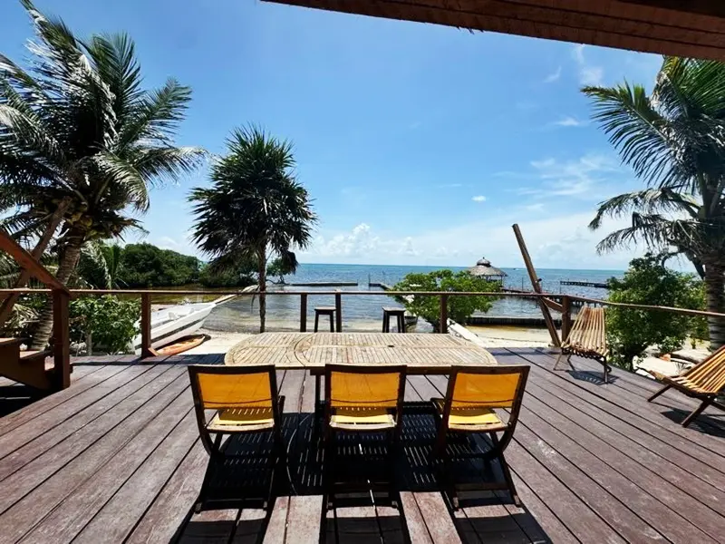 A table and chairs on the deck of a house