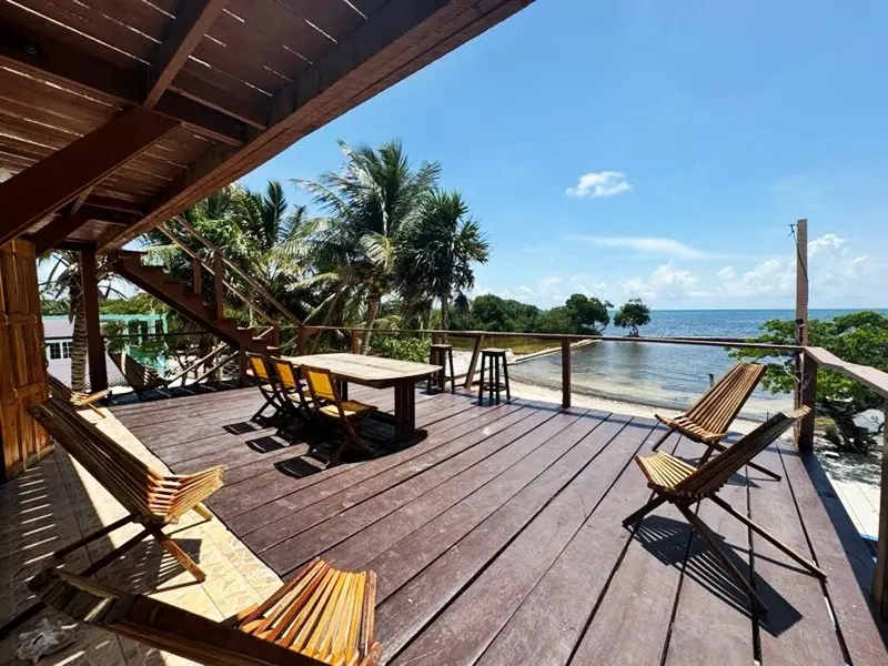 A deck with chairs and tables on the beach