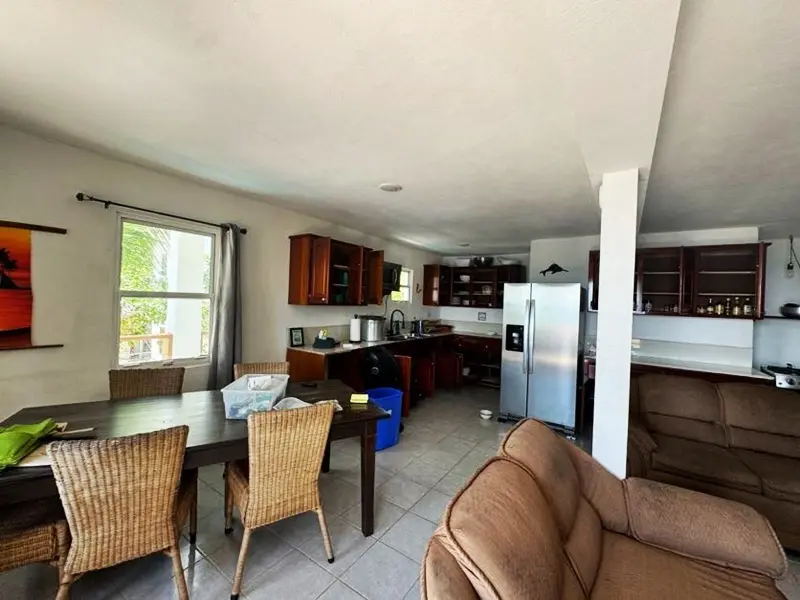 A living room with a couch, table and chairs.