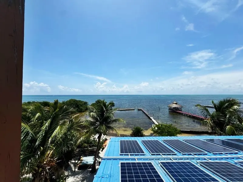 A view of the ocean from above with solar panels.