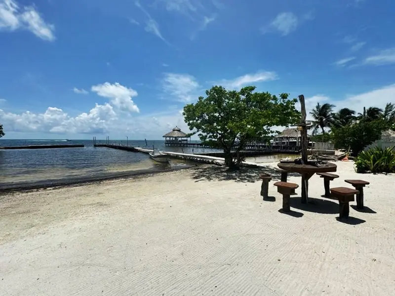 A beach with tables and chairs on it