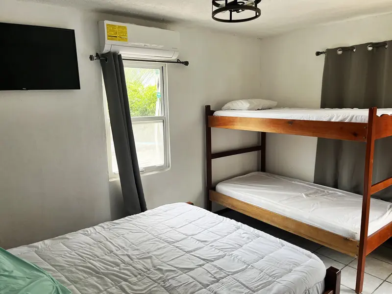 A bedroom with two bunk beds and a tv.