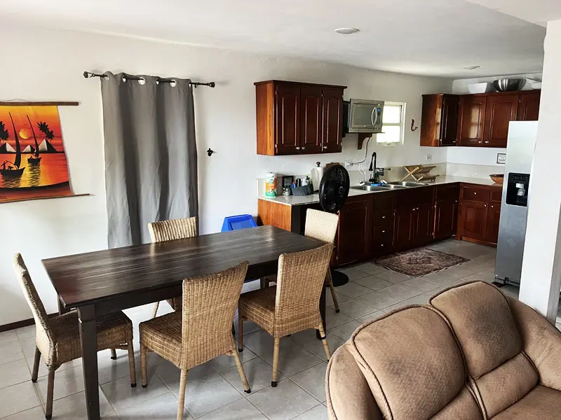 A living room with a dining table and chairs