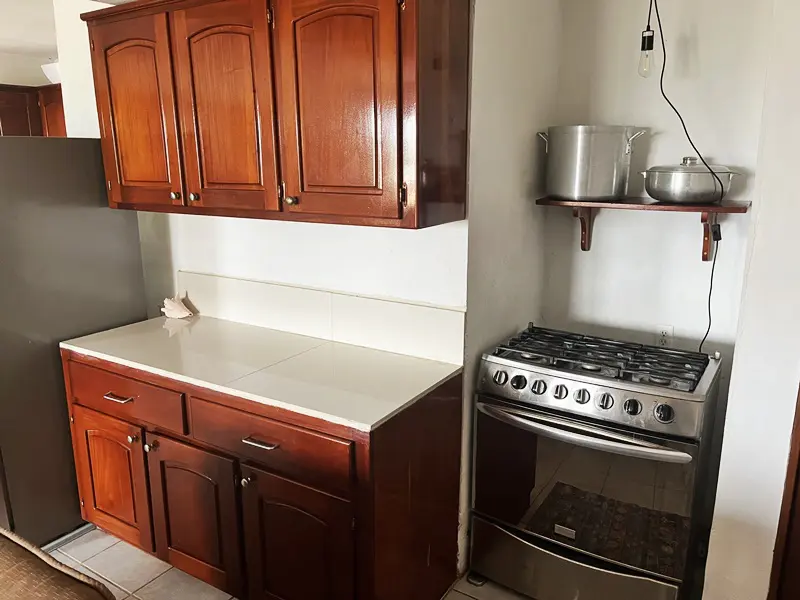 A kitchen with wooden cabinets and a stove.