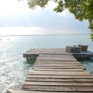 A dock with a boat in the water.