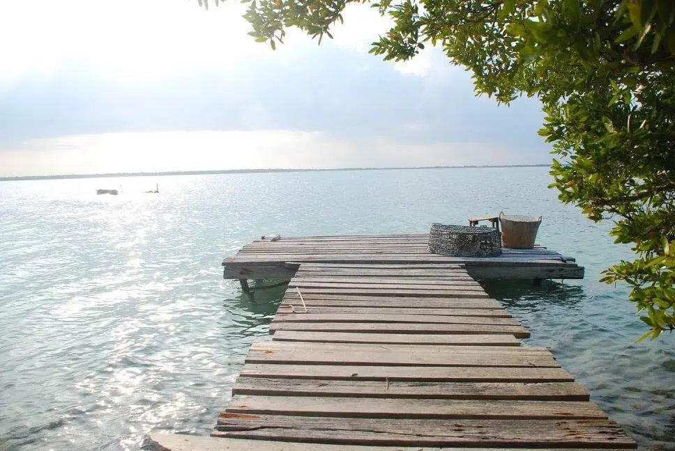 A dock with a boat in the water.