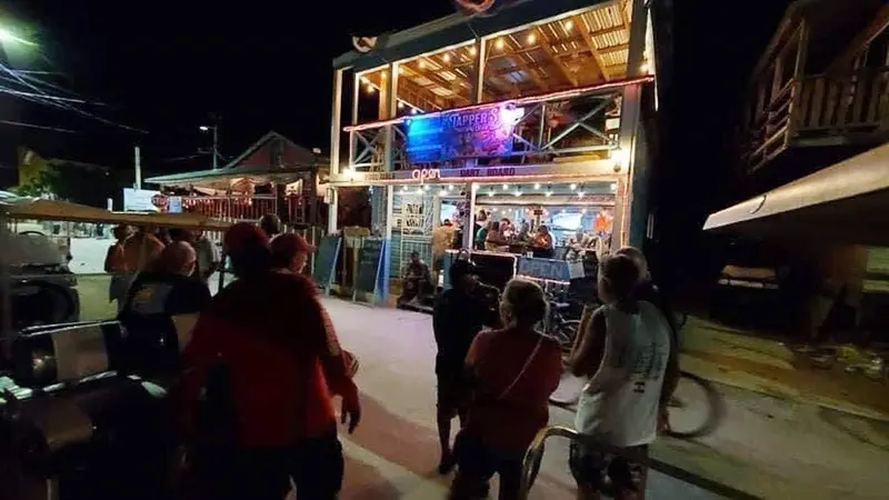 A group of people standing around at night.