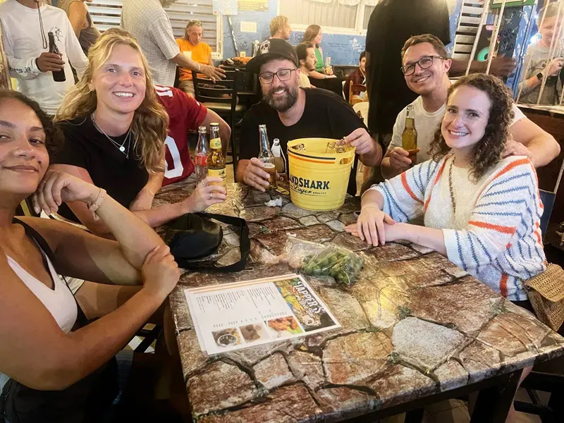 A group of people sitting at a table with drinks.