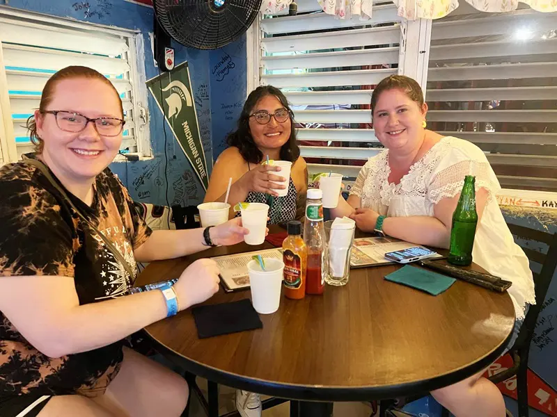 A group of people sitting at a table with drinks.