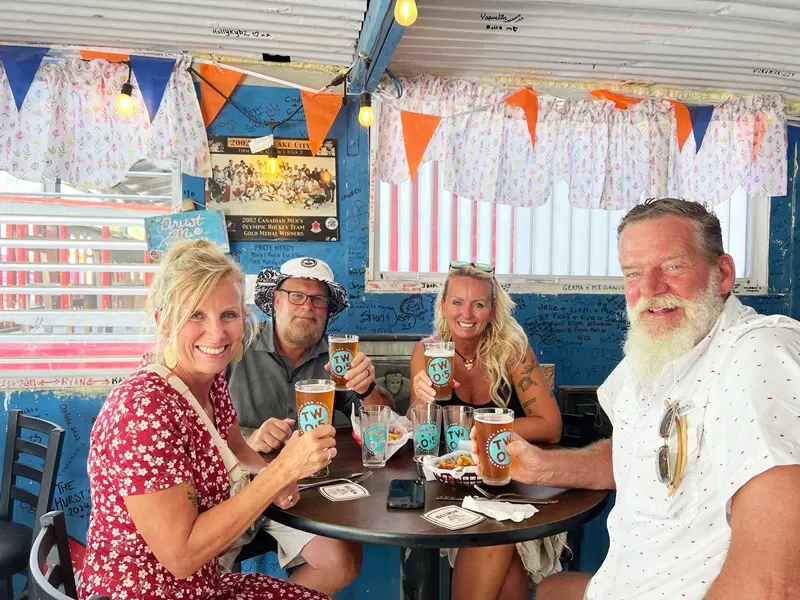 A group of people sitting at a table with drinks.