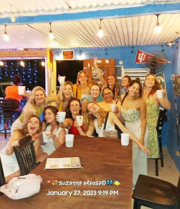 A group of women sitting at a table with drinks.