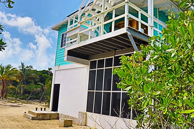 A building with a balcony and an open window.